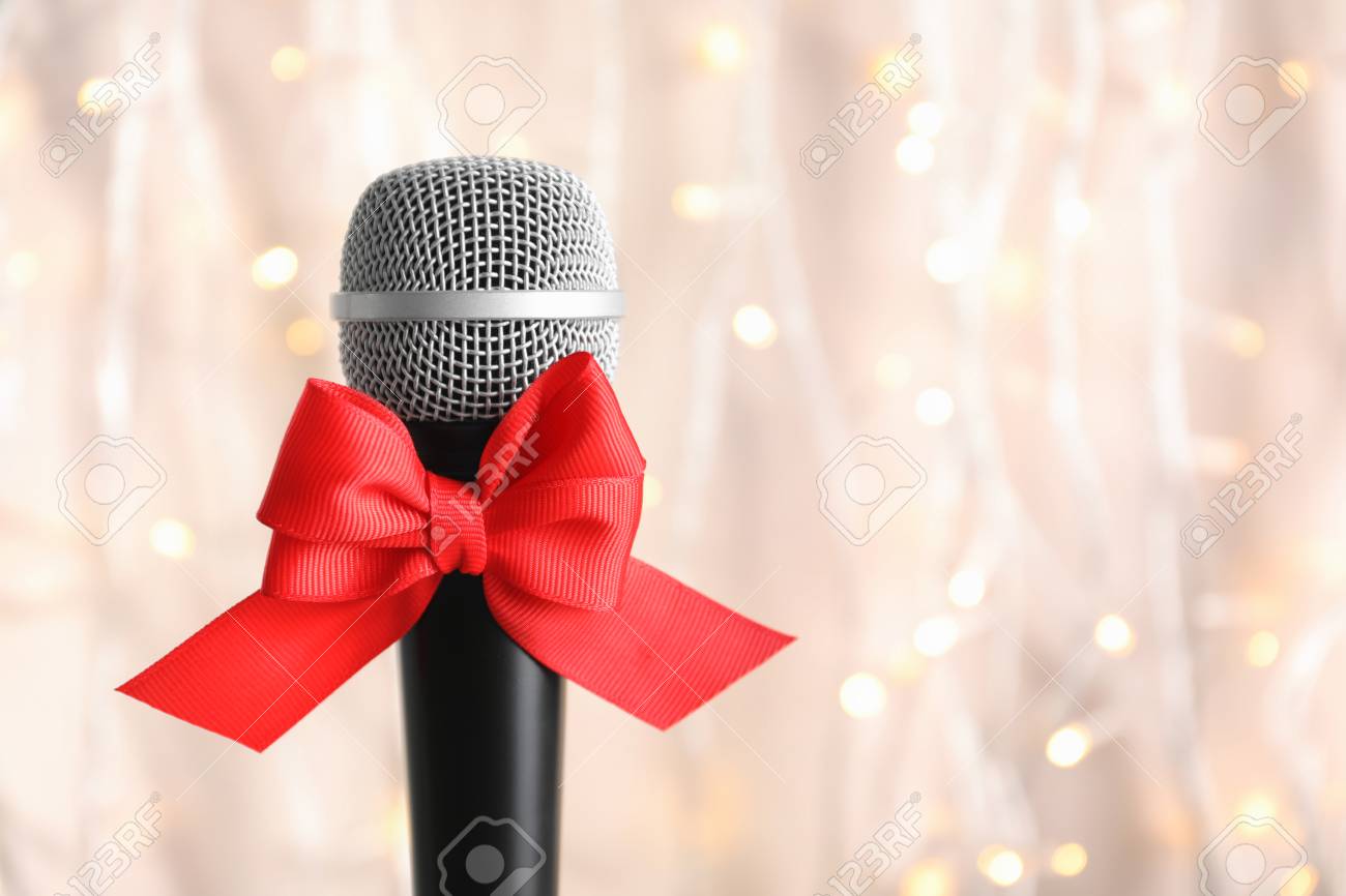 106366109-microphone-with-bow-on-blurred-background-christmas-music-concept.jpg