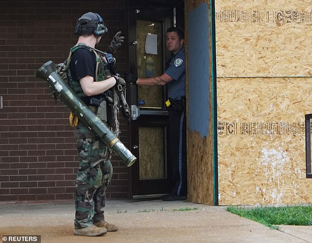 30257882-8478155-The_police_department_s_windows_were_boarded_up_to_protect_them_-a-5_15935911...jpg