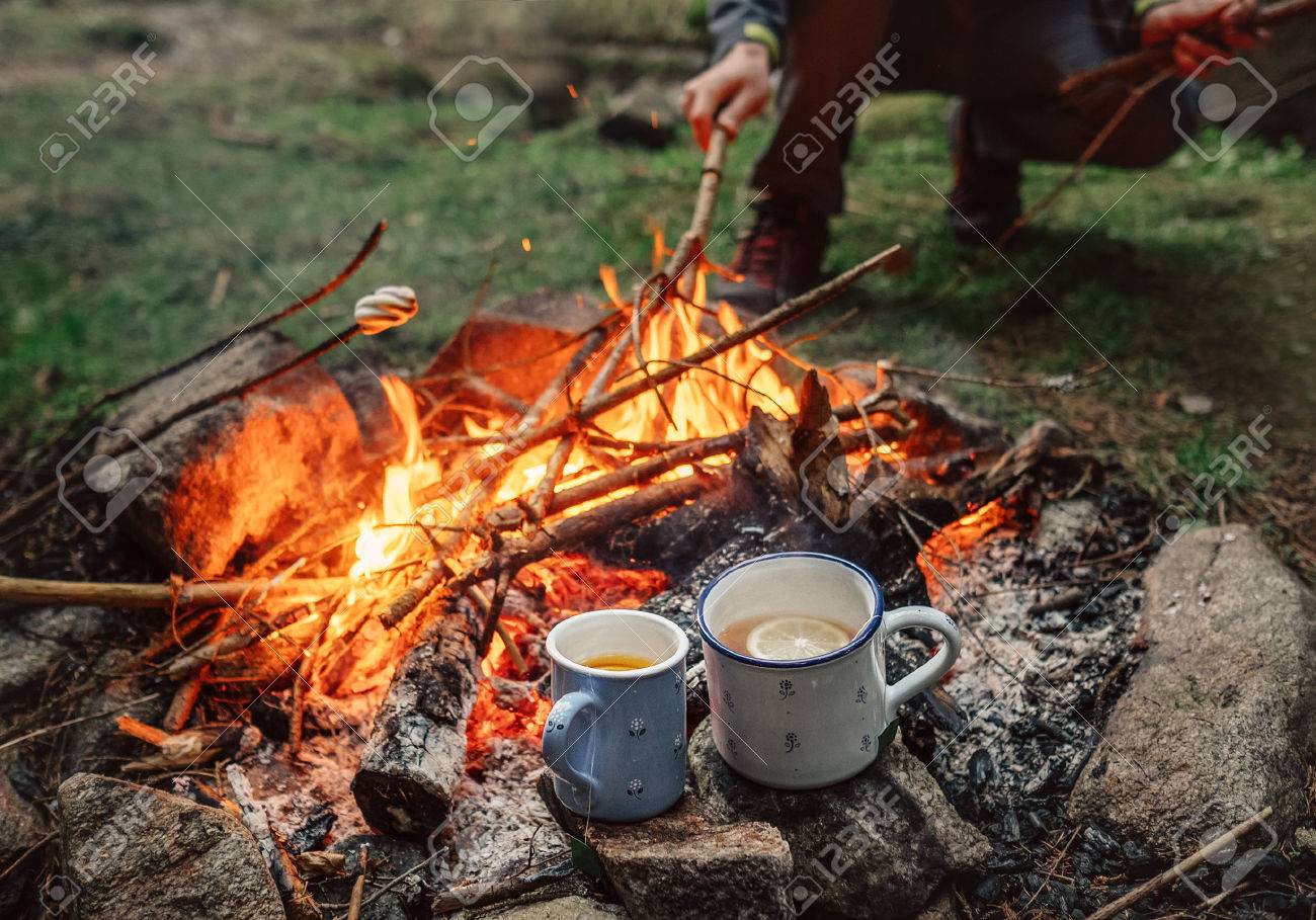 75443207-two-big-mugs-with-hot-tea-and-lemon-near-the-campfire-place.jpg