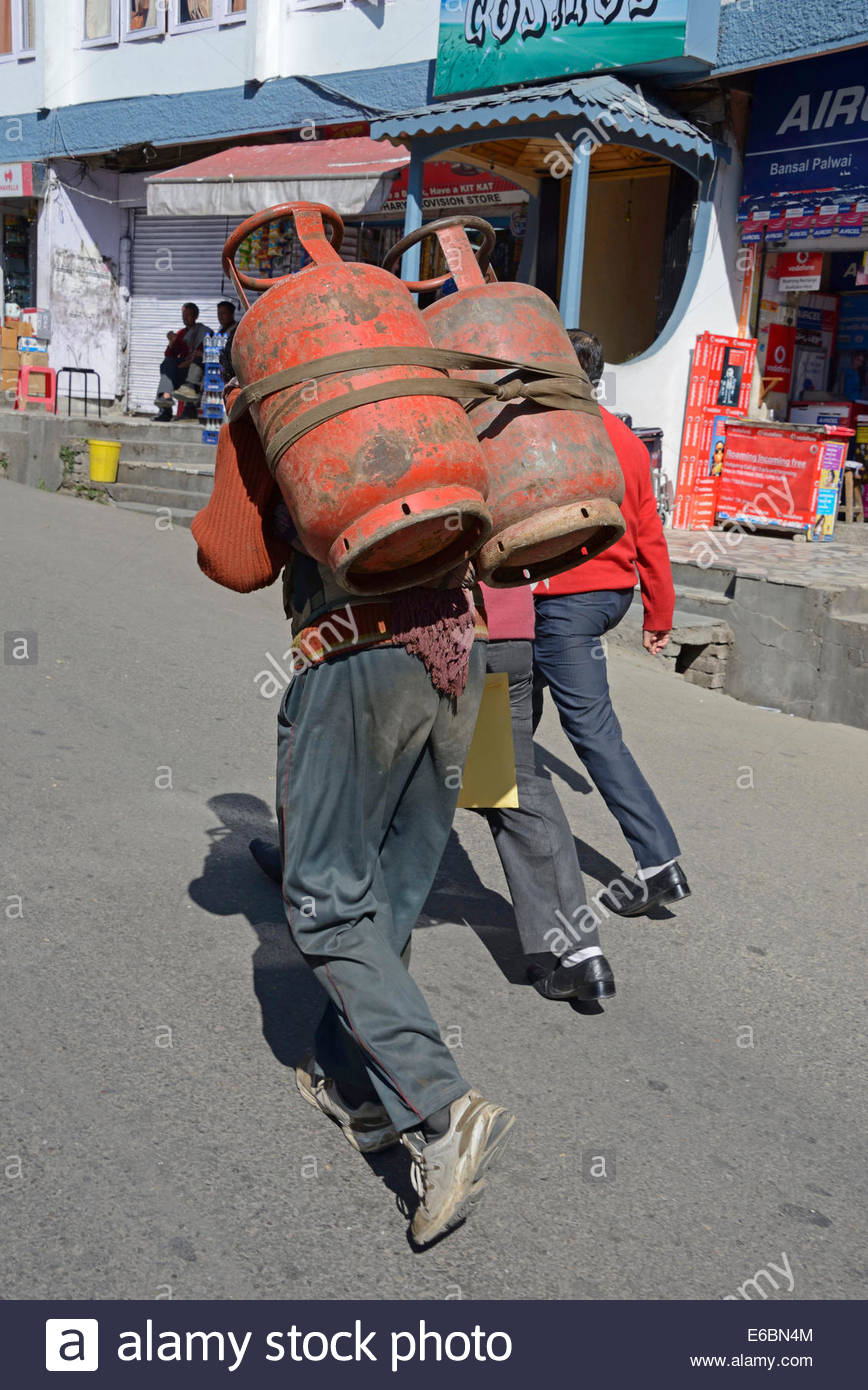 a-man-carrying-tow-filled-gas-cylinders-on-his-back-in-mall-road-shimla-E6BN4M.jpg