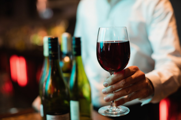 bartender-holding-glass-red-wine_107420-65841.jpg