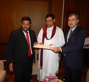 HE-Qasim-Qureshi-L-presenting-cheque-to-Minister-Basil-Rajapaksa-and-Minister-Bathiudeen-300x276.jpg