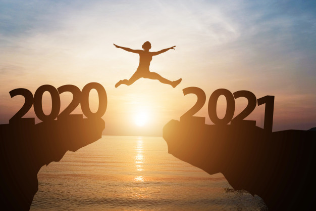 man-jumps-from-year-2020-2021-with-sunlight-sea-as-background_50039-1549.jpg