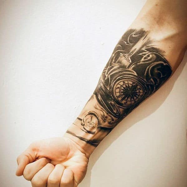 man-with-forearm-sleeve-tattoo-of-compass-and-candle-flame.jpg