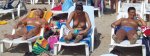 3_Topless_Females_Sunbathing_on_a_Beach.jpg