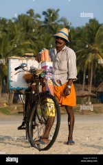 happy-icecream-seller-on-hawah-beach-with-his-icecream-bicycle-BTGT4J.jpg