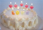 cake-with-heart-shaped-candles-and-spelling-love-~-u11404228.jpg