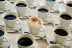 one-cup-of-cappuccino-amongst-cups-of-black-coffee-elevated-view-~-72983871.jpg